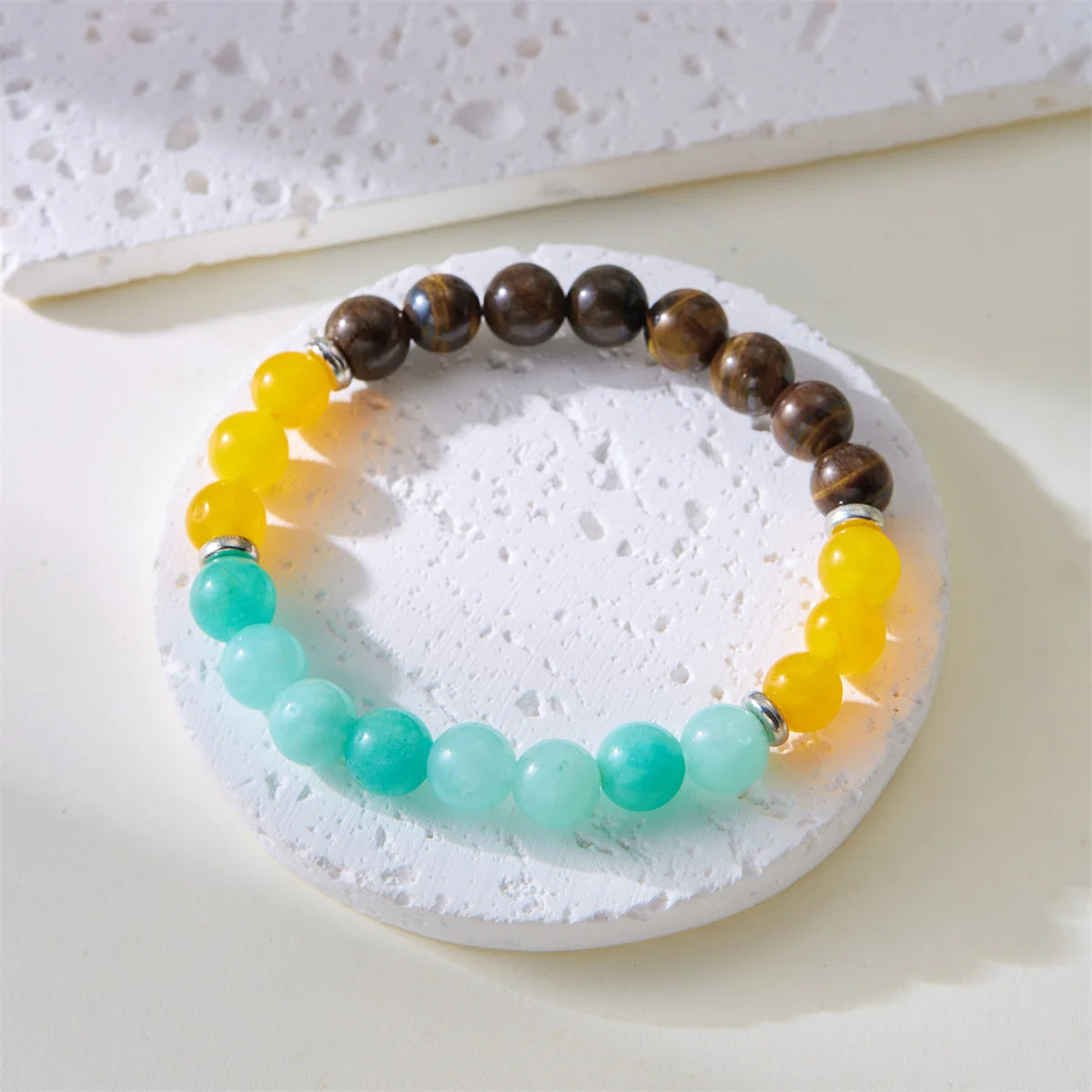 Bohemian style charm bracelets on model’s wrist