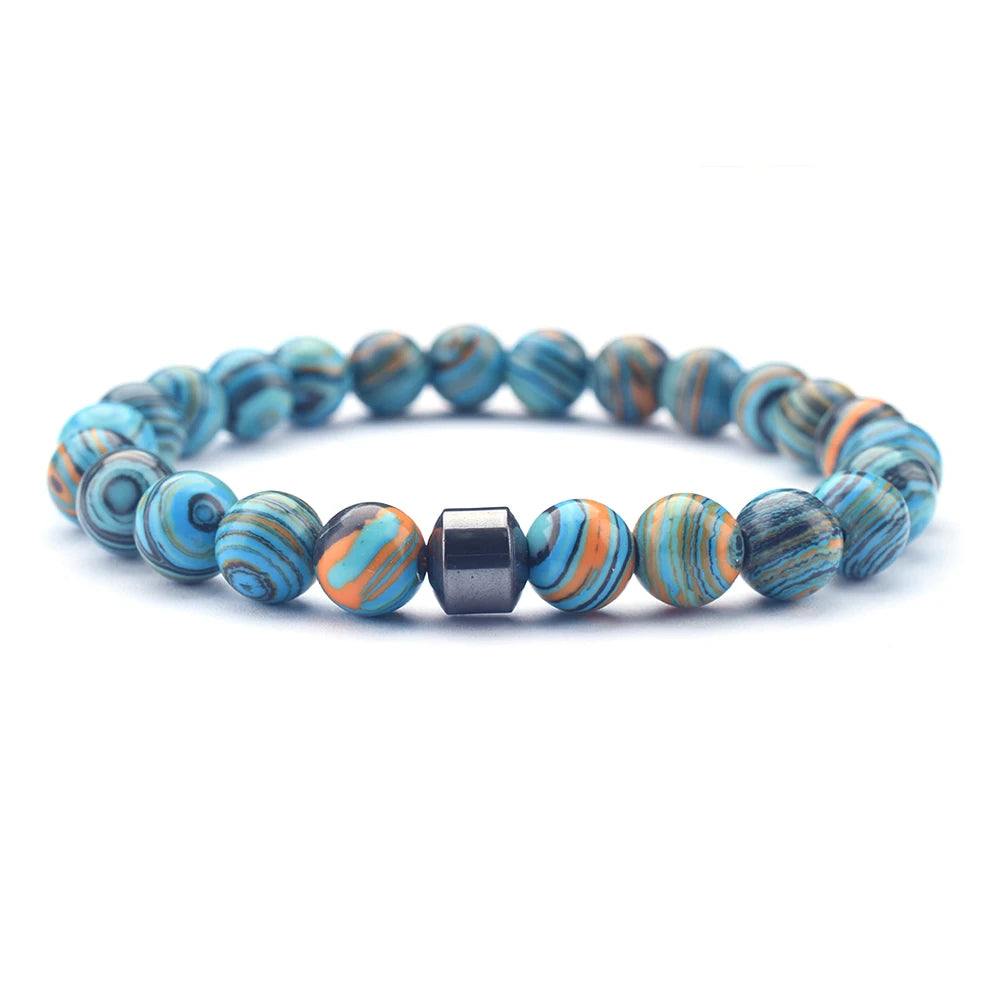 Bracelet with earthy tones placed on moss
