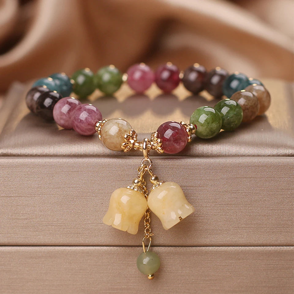 Close-up of light luxury tourmaline bracelet with lantern pendant