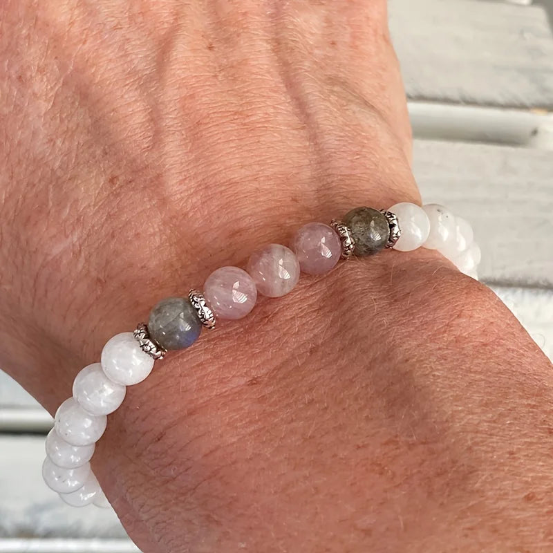 Close-up of natural stone bracelet showcasing shimmering labradorite and soft pink rose quartz