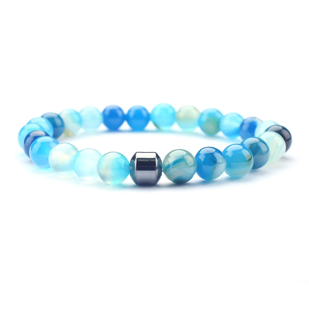 Crystal bracelet set with blue line agate beside it
