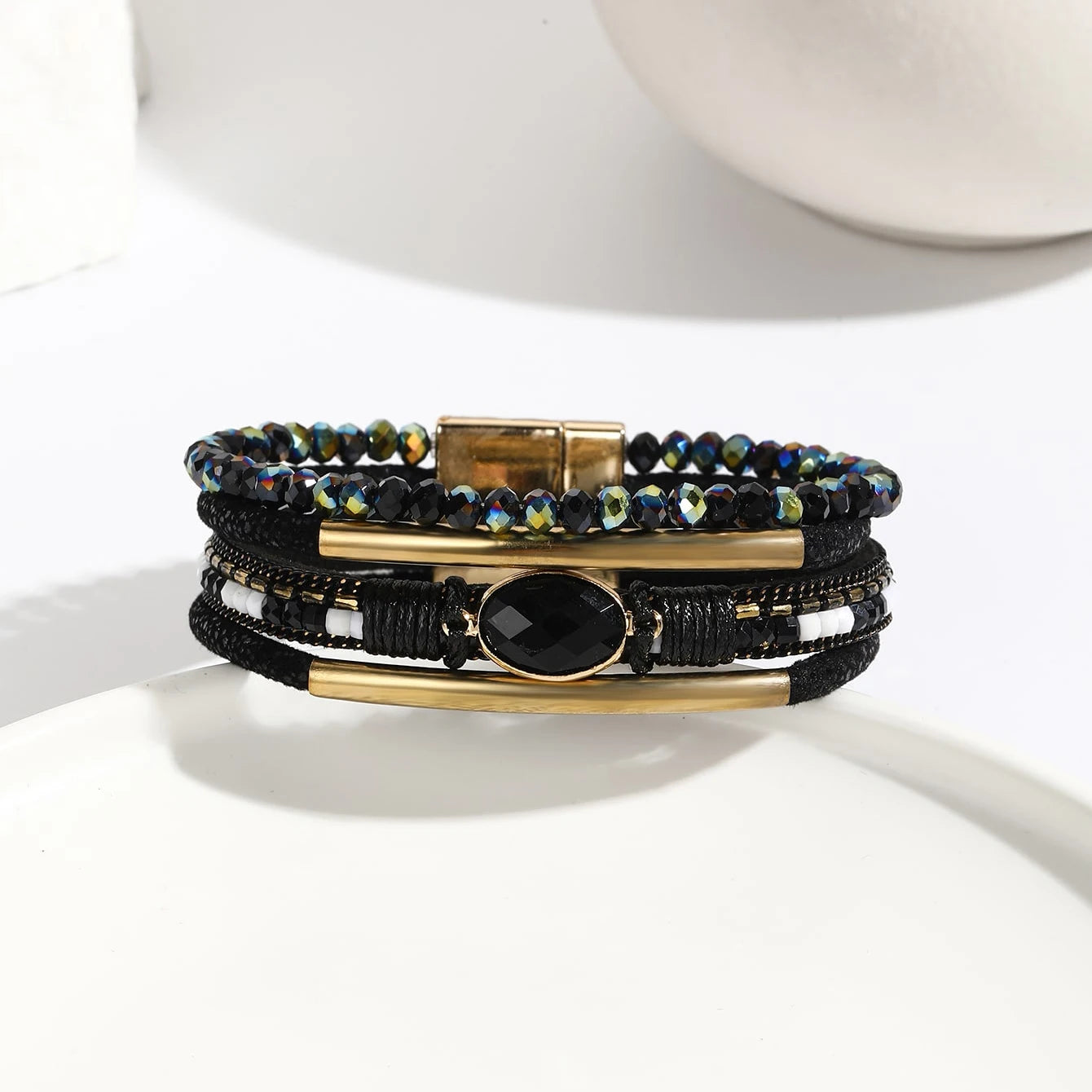 Leather wrap bracelet styled with boho rings
