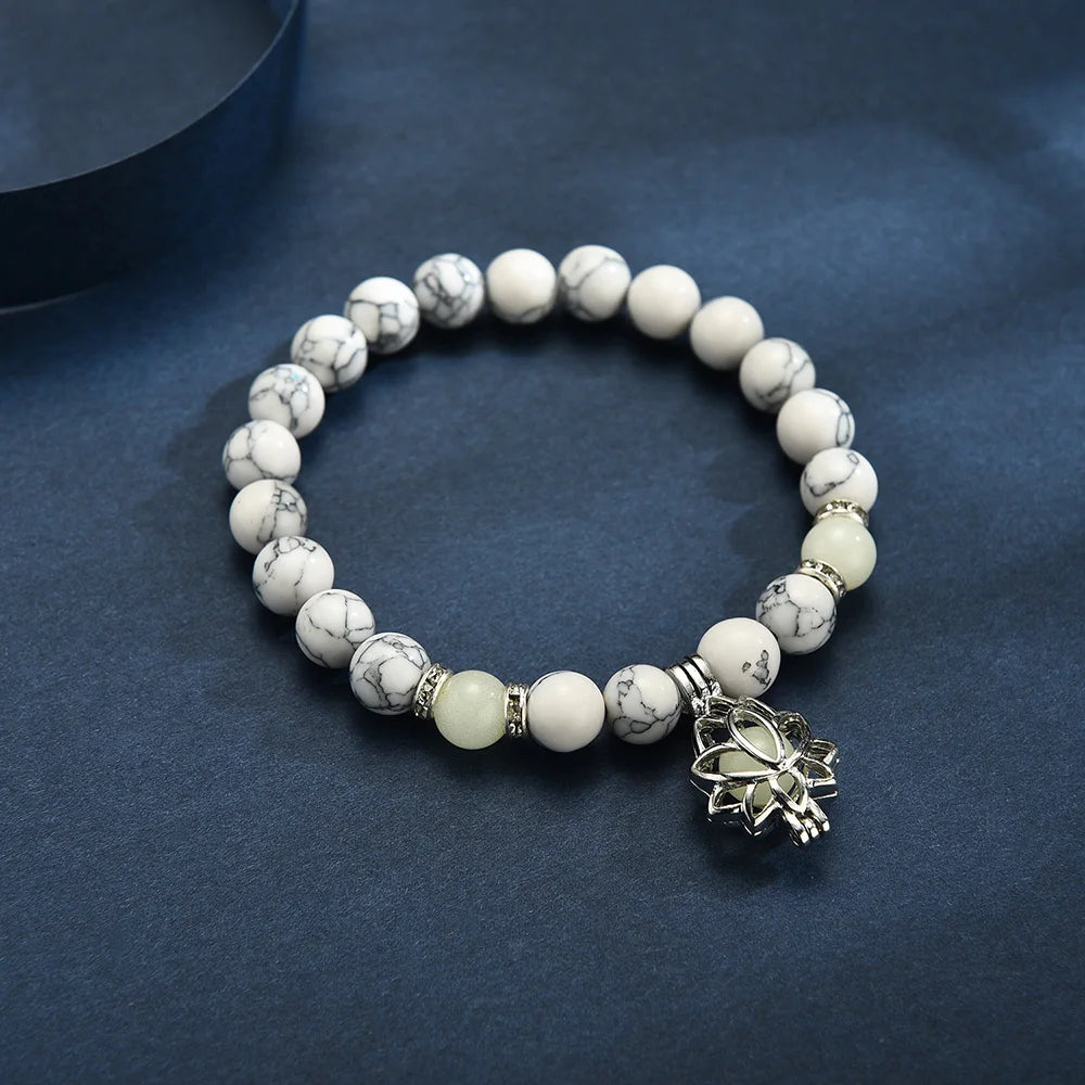 Lotus charm glowing in the dark on bracelet