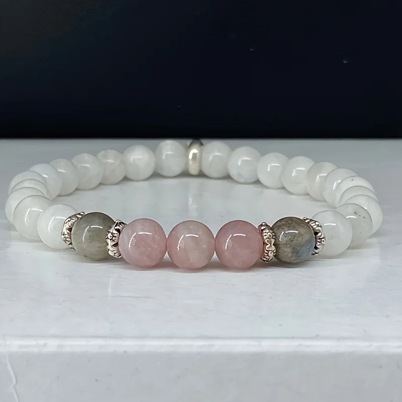 Mystic Moon Trio Bracelet with labradorite, moonstone, and rose quartz beads on a neutral background