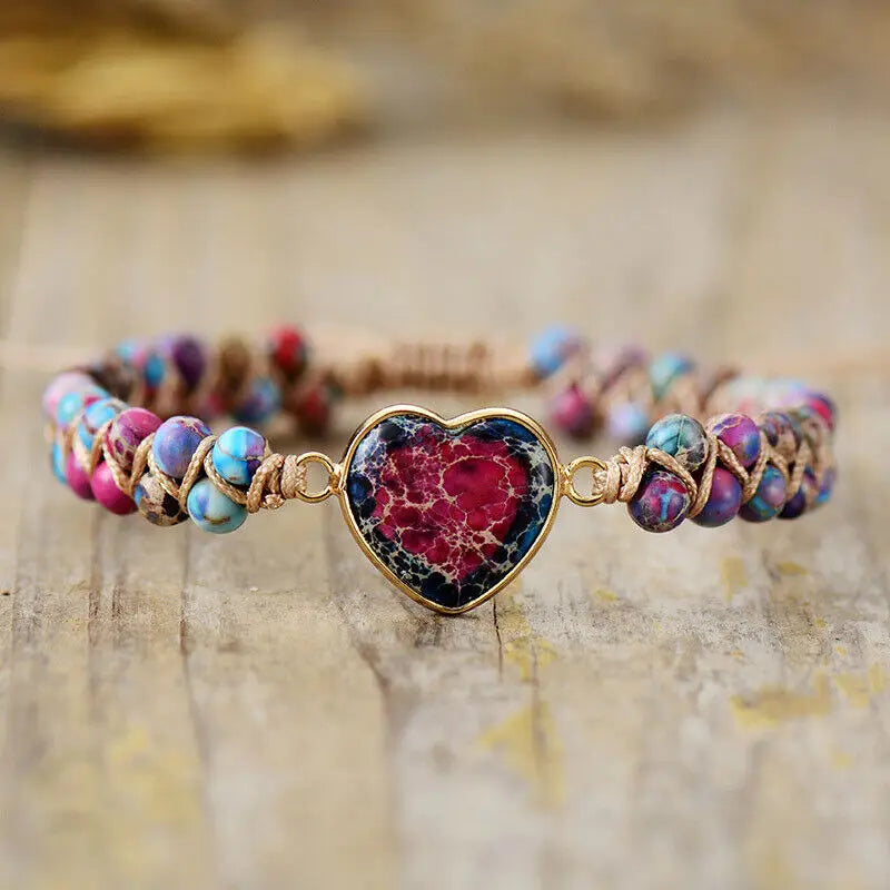 Pink and turquoise heart stone bracelet on smooth rock