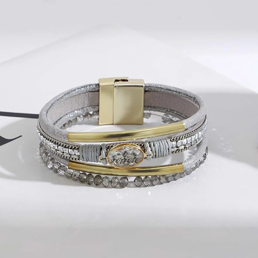 Stack of leather cuff bracelets in assorted colors