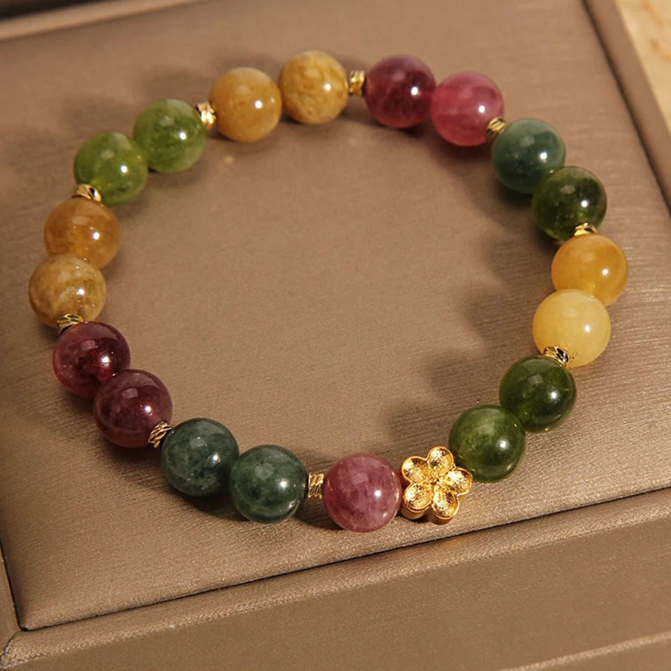 Vintage-inspired charm bracelet with soft pink and green tones