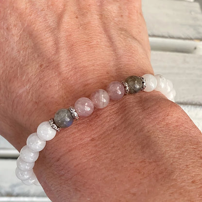 Close-up of natural stone bracelet showcasing shimmering labradorite and soft pink rose quartz