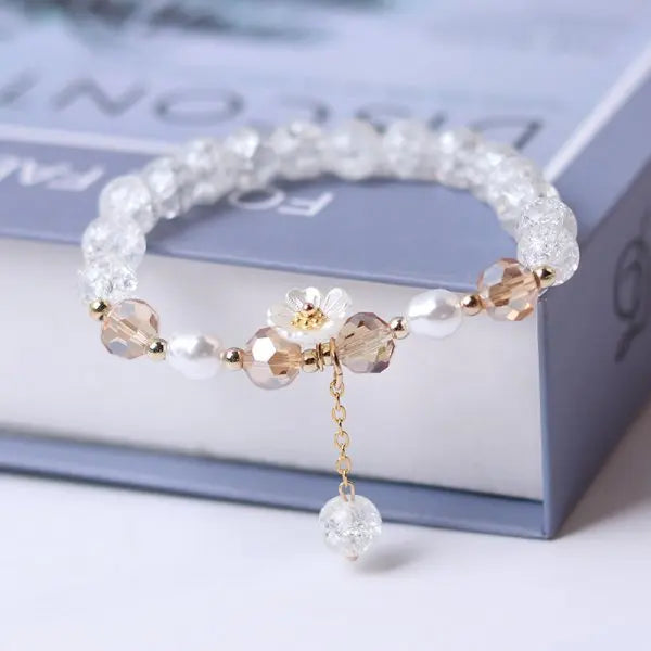 Close-up of sparkling crystal beads and flower-shaped charm