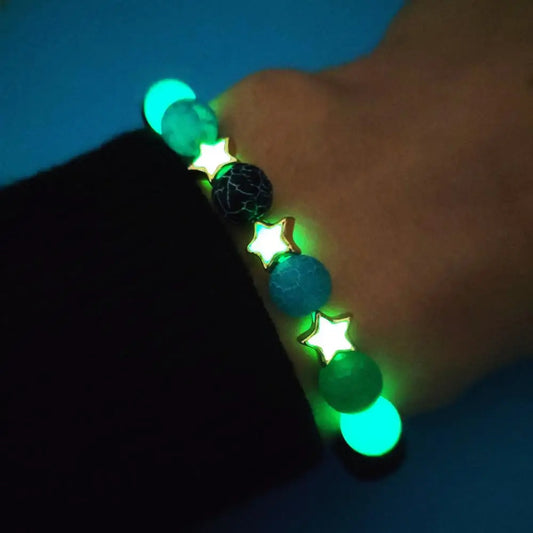 Glow-in-the-dark mandala bracelet on natural wood background