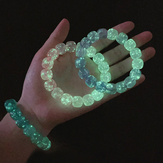 Luminous bracelet glowing green in the dark