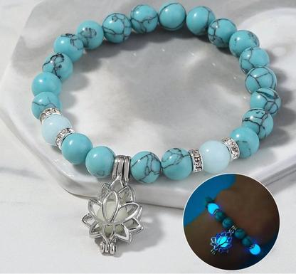 Natural stone bracelet with lotus charm on wrist