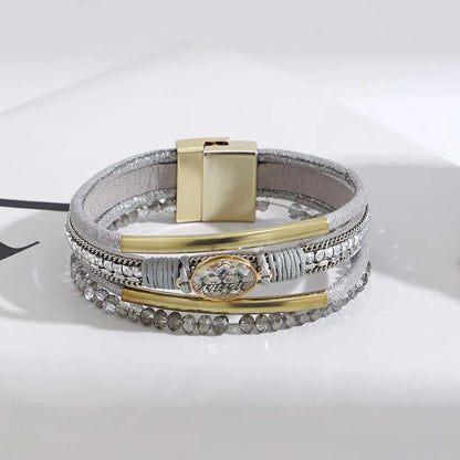 Stack of leather cuff bracelets in assorted colors